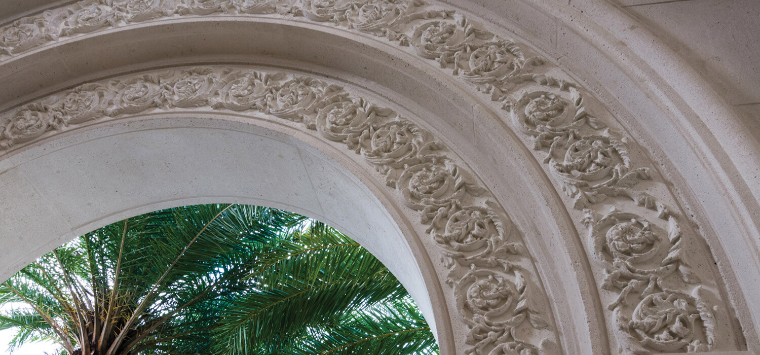 cast stone arched entranceway with filigree